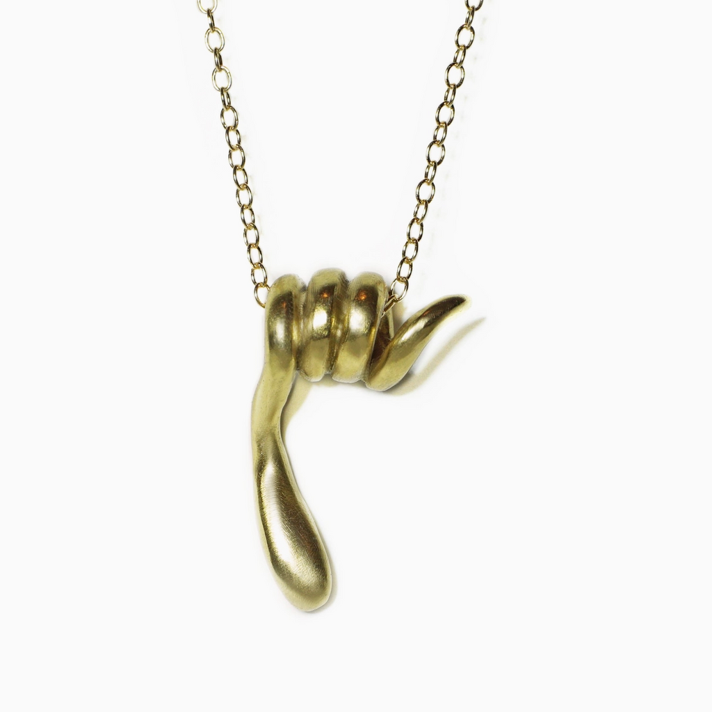 Gold necklace with a snake pendant on a white background